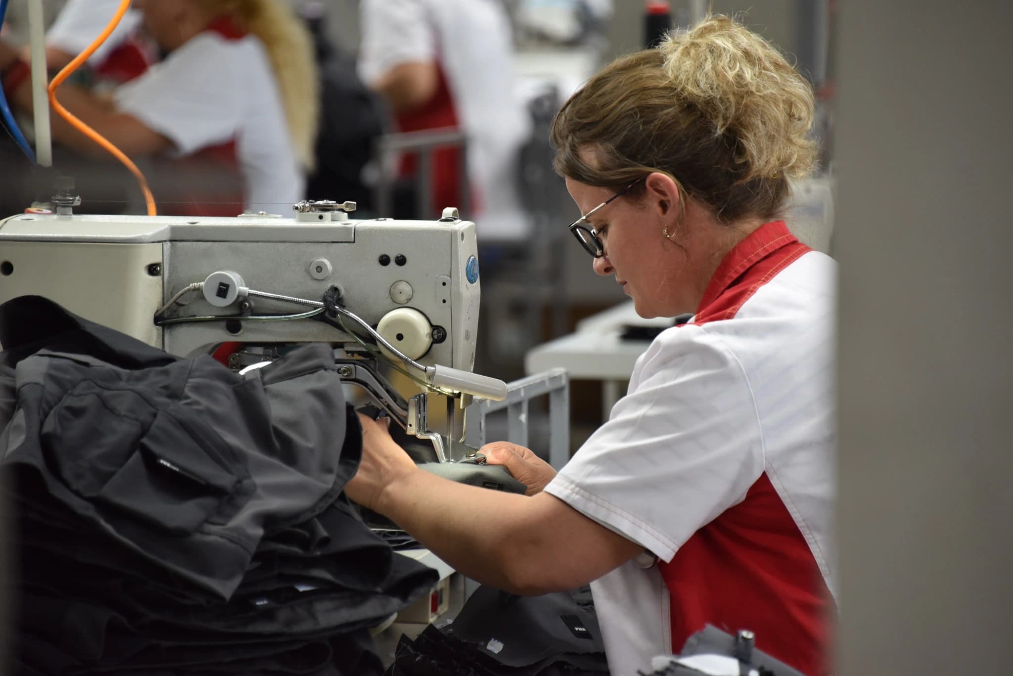 Operator assembling a workwear garment