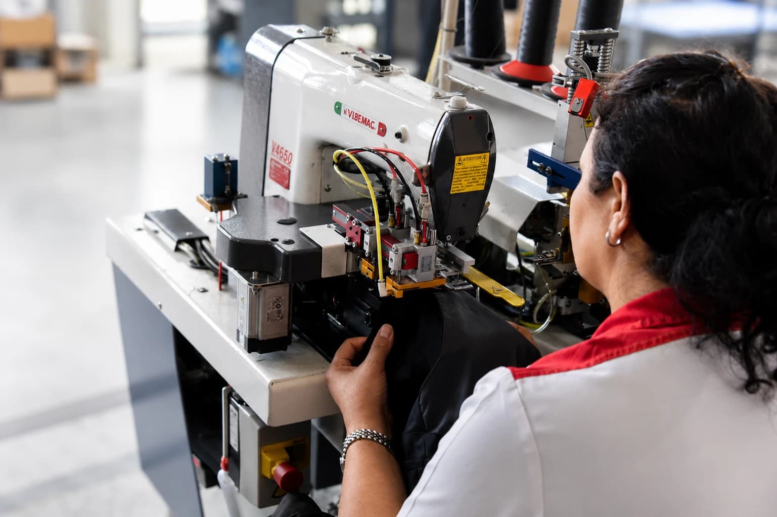 Operator sewing a workwear panel on an automated machine